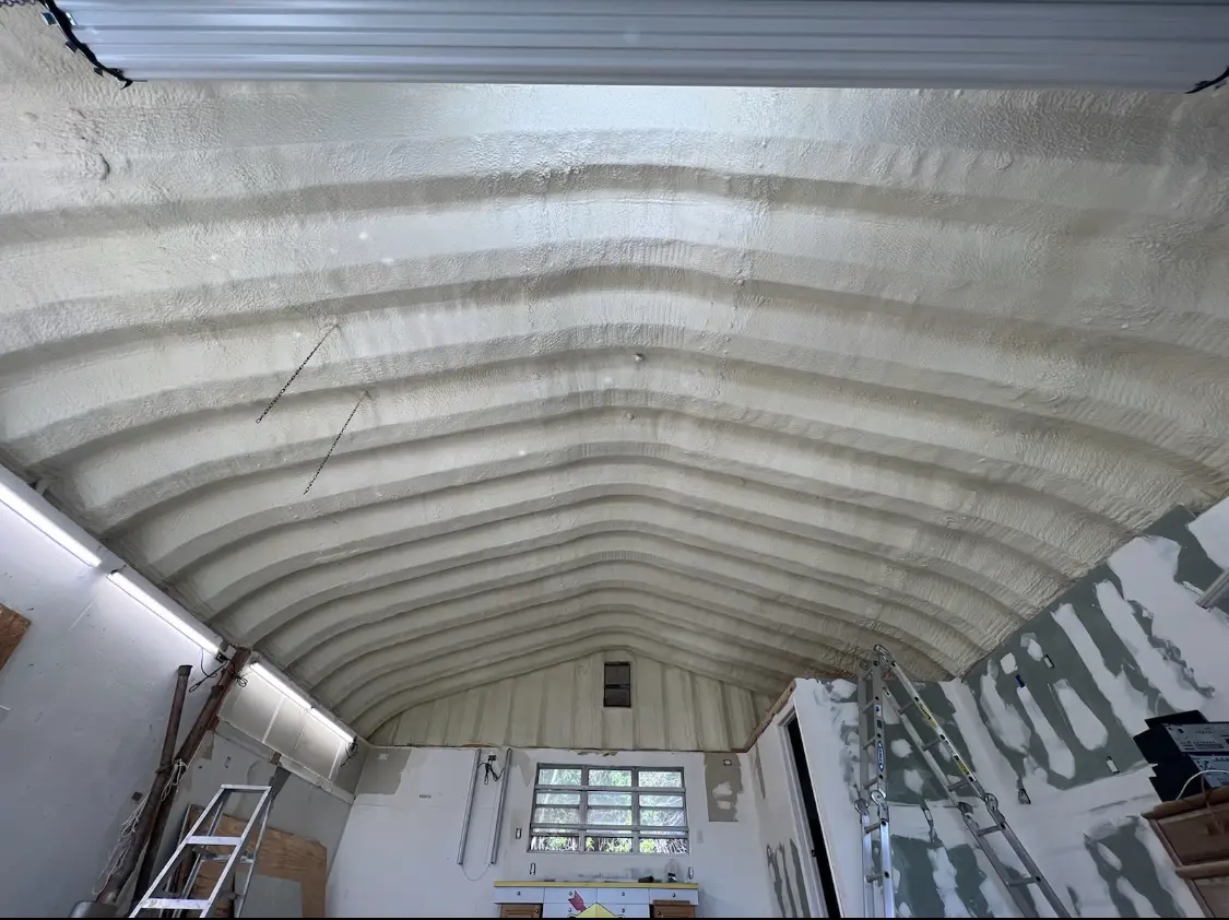 Spray polyurethane foam applied to the underside of a metal roof deck in Neenah
